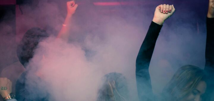 Woman Wearing Black Long-sleeved Shirt Dancing With Smoke